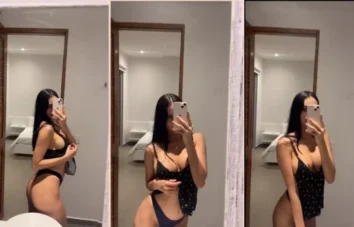 Elizabeth Marquez com o celular na mão registrando umas cenas picantes