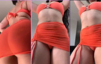 Lis Del Castilho de saia laranja mostrando seu corpão